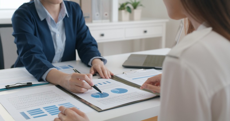 People discussing investments with pie charts by the Law Offices of Robert E. O’Connor