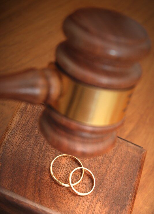 A gavel with wedding rings near it by the Law Offices of Robert E. O’Connor